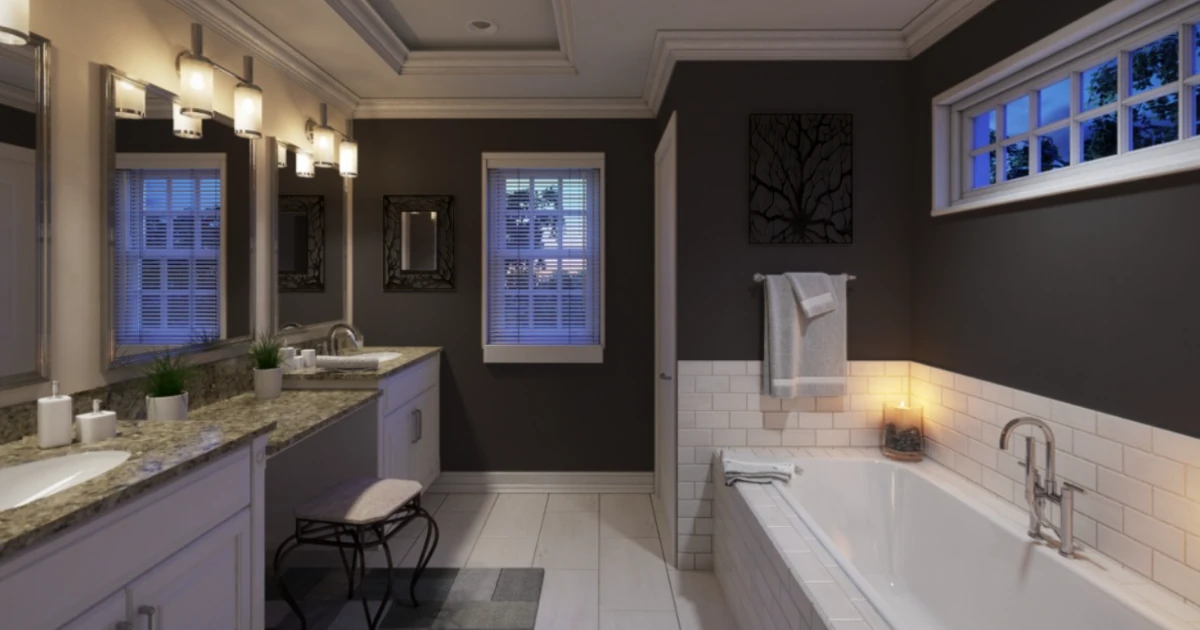 A dimly lit bathroom with near-black walls, white subway-tile wainscoting, a soaking tub, and a lit candle, photographed in the evening.