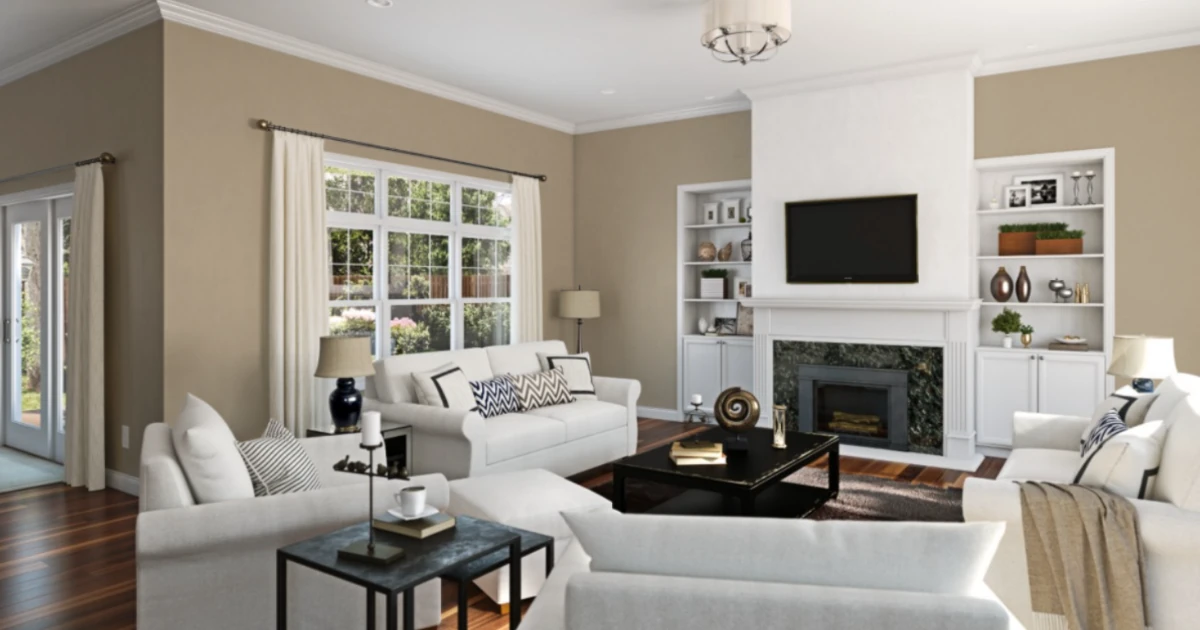 A furnished living room with white crown moulding, built-in shelving flanking a fireplace, tan walls, and light upholstered seating.