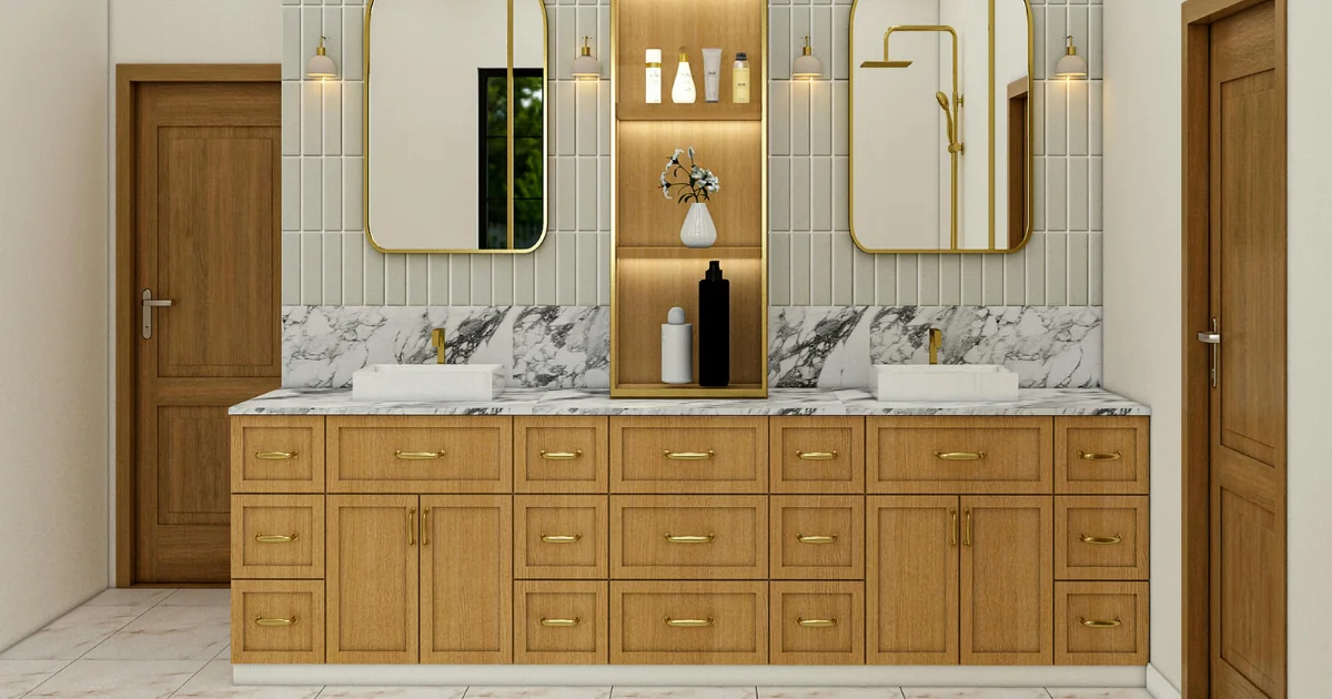 Bathroom vanity with pale vertical tile, marble backsplash, wood cabinetry, and brass-framed mirrors.