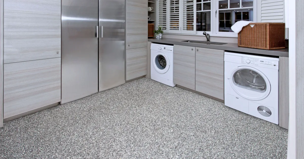 Finished gray flake floor coating in a residential laundry and utility room.