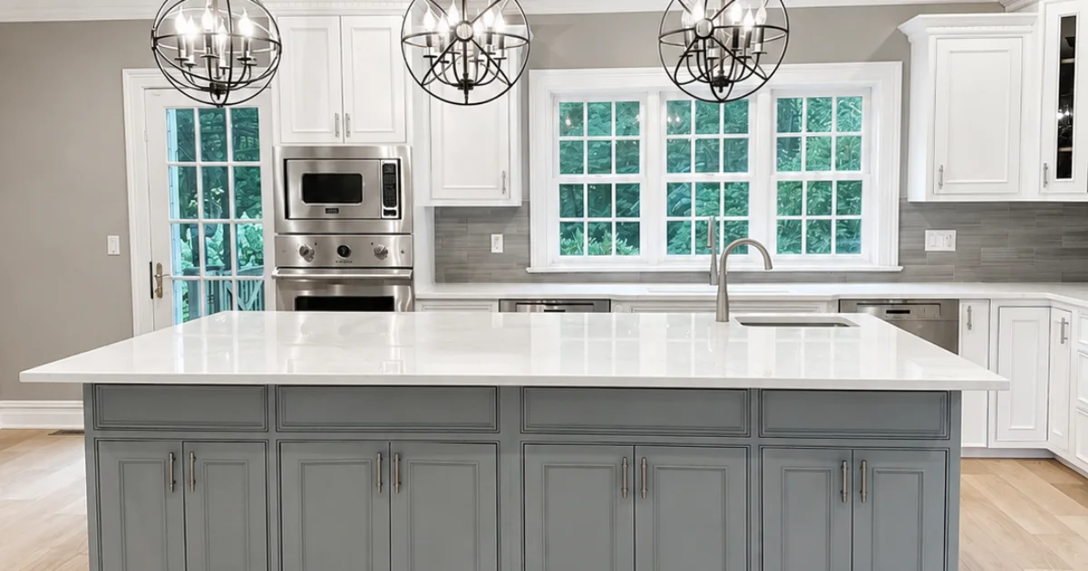 Updated kitchen with white perimeter cabinets and a gray painted island.
