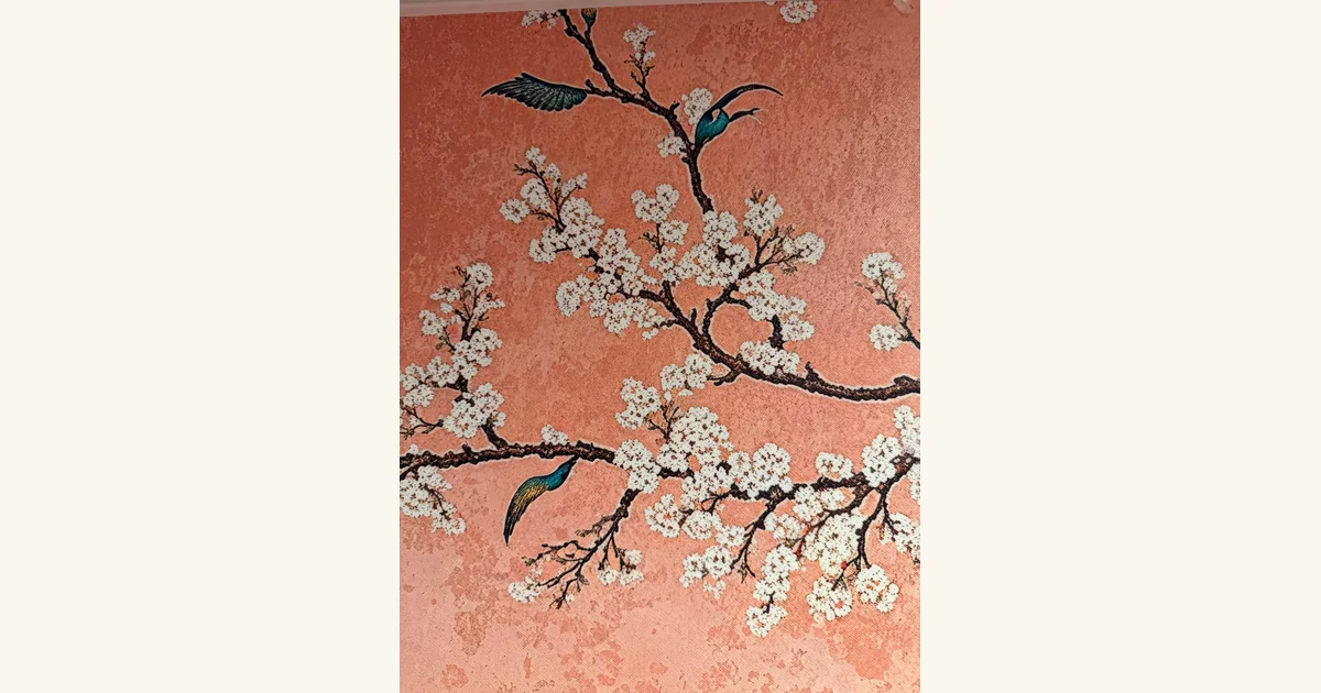 Close-up of the mural showing dark birds blending into flowering tree branches.