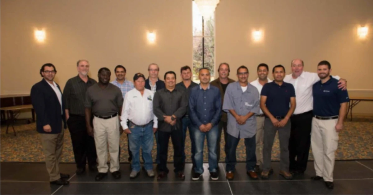 George P. Williams standing with members of the A.G. Williams Painting Company team at a company gathering.