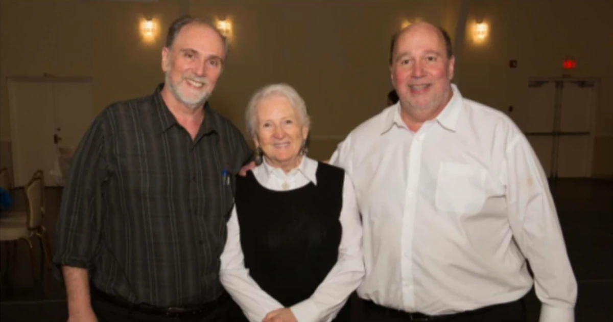 Arthur G. Williams and George P. Williams standing with a woman at an A.G. Williams gathering.