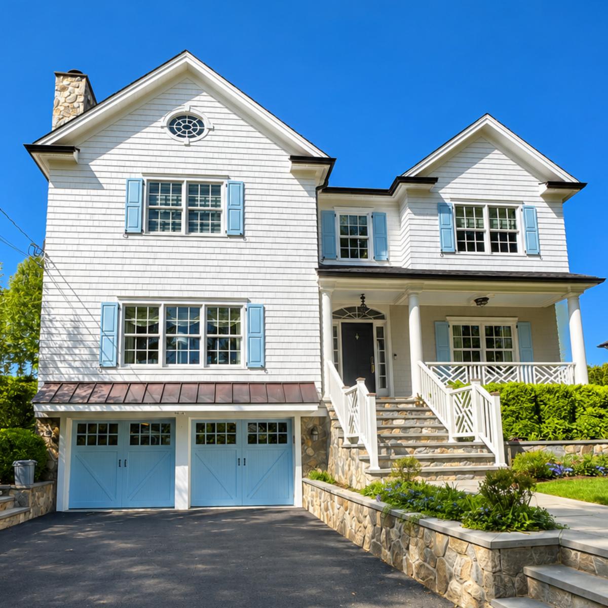 Finished exterior painting project with white siding and blue shutters.
