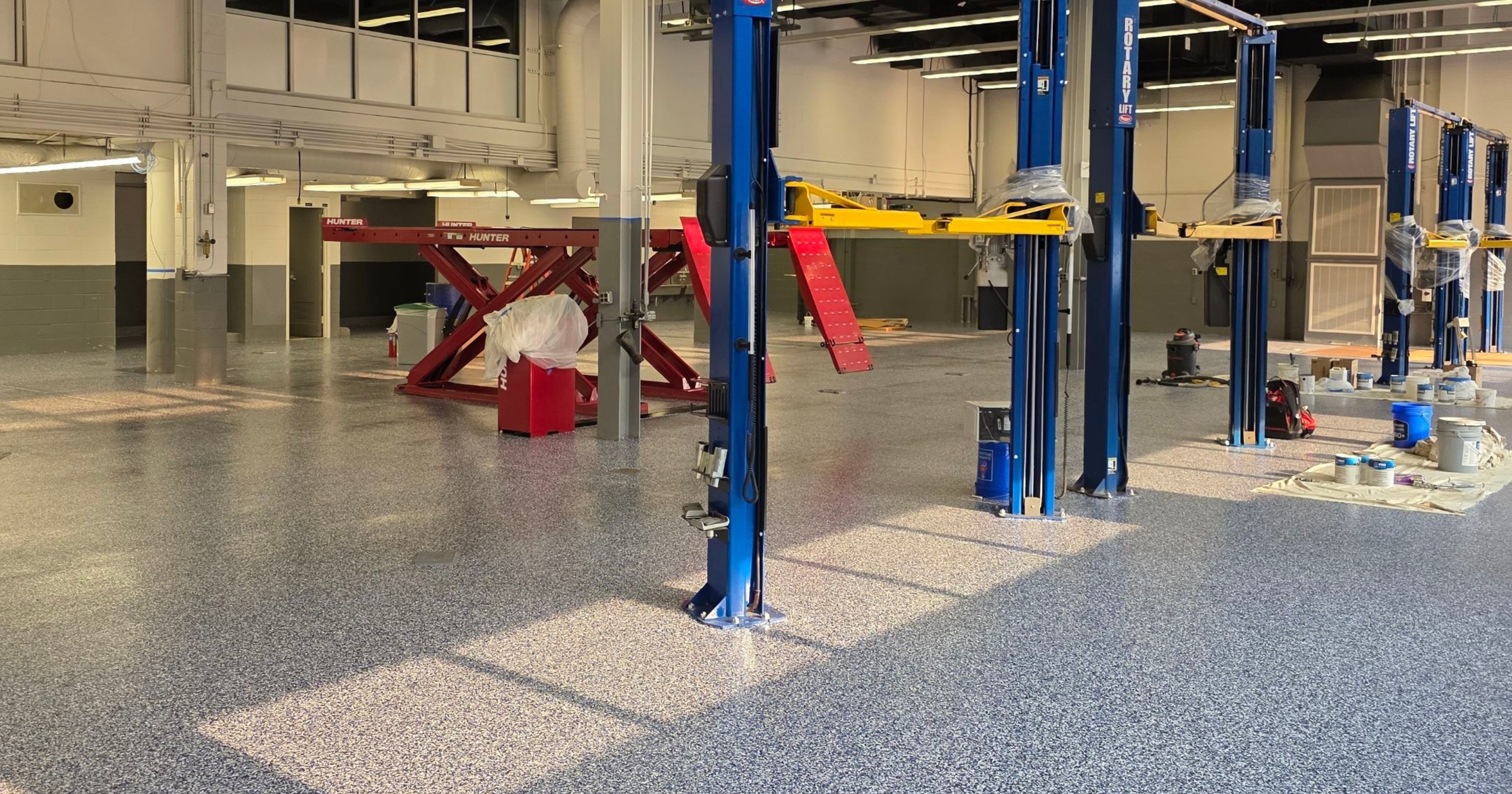 Textured anti-slip floor coating in an automotive service shop.